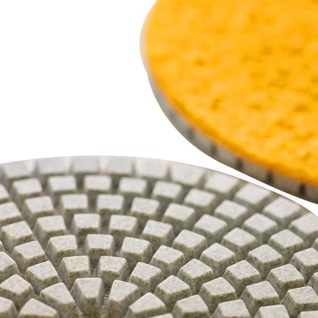 Segmented polishing pad face with layered edge and Hook and Loop backing detail