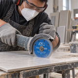 Workshop scene showing the blue mesh turbo blade cutting ceramic tile