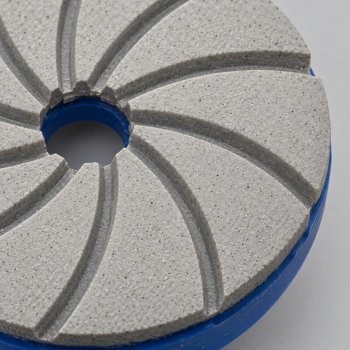 Close-up of the textured resin working face, curved grooves and blue backing edge.