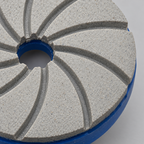 Close-up of the textured resin working face, curved grooves and blue backing edge.