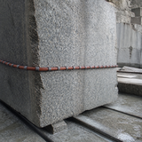 Rubber coated diamond wire saw cutting a granite quarry block